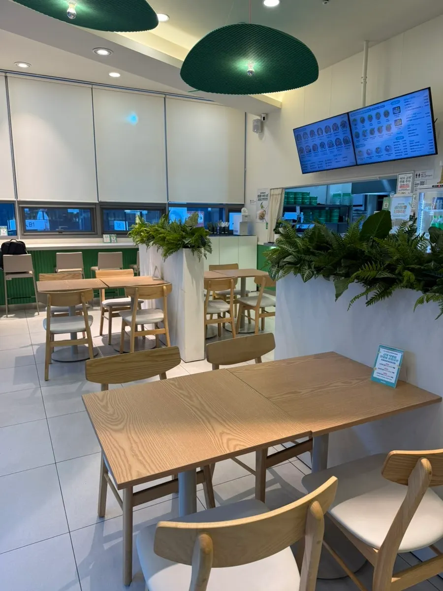 Interior of Salering Gyodae Direct Store with white and green tones and plant decor