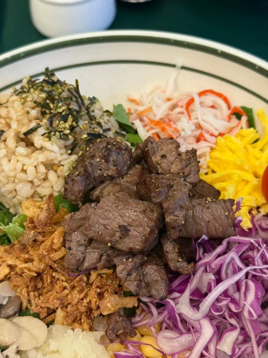 Grilled steak bibim poke topped with crab meat, egg, and vegetables