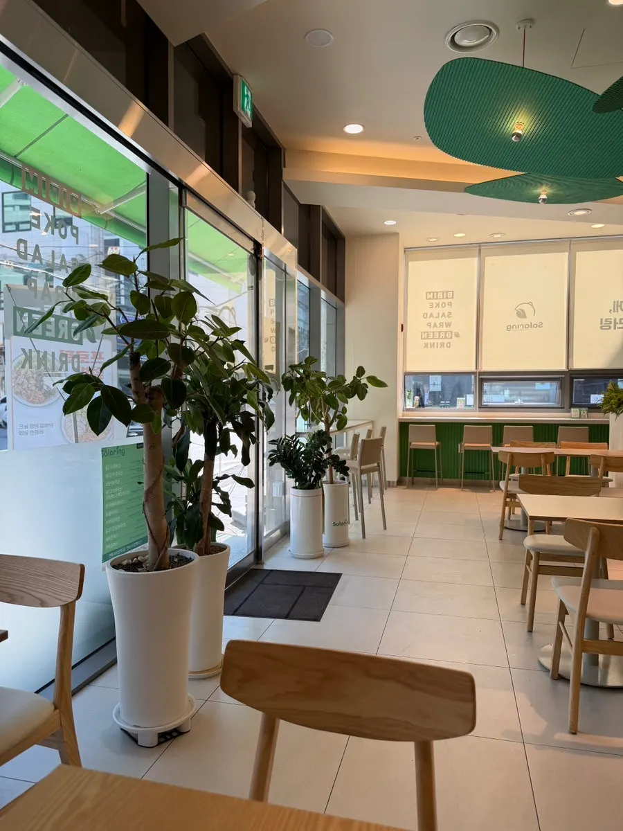 Bright interior with 2-seat tables at Salering Gyodae Direct Store