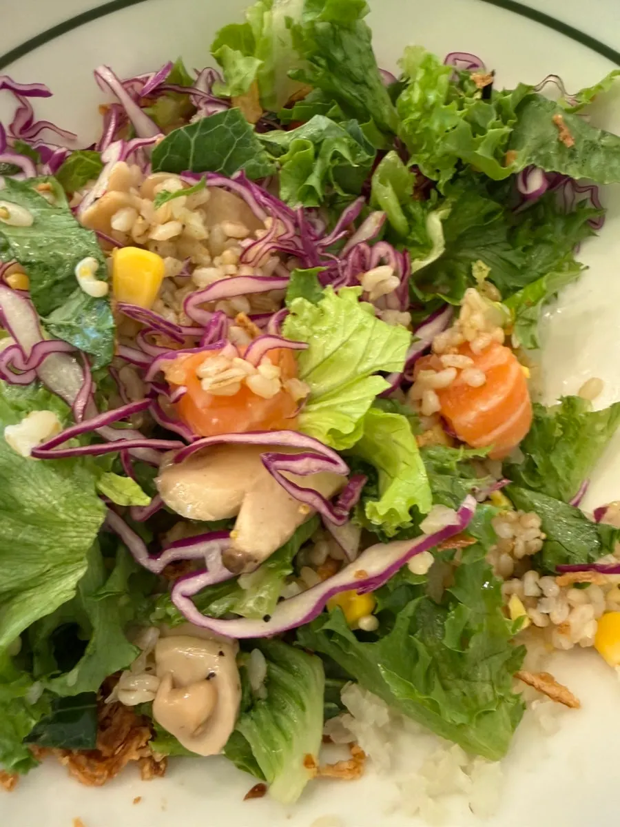 Raw salmon and brown rice poke topped with lots of ingredients