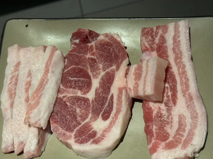 Three types of raw meat: pork jowl, pork neck, and pork belly