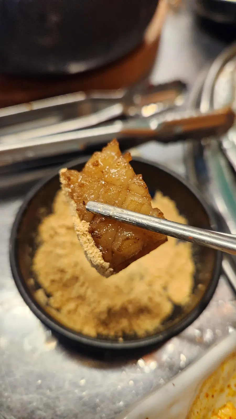 Beehive-cut pork skin grilling over the charcoal fire