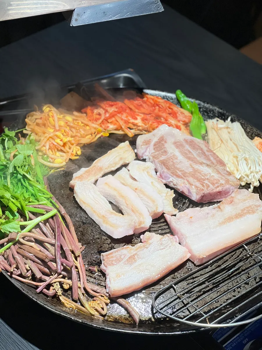 Raw plate of pork belly, pork neck, and pork jowl