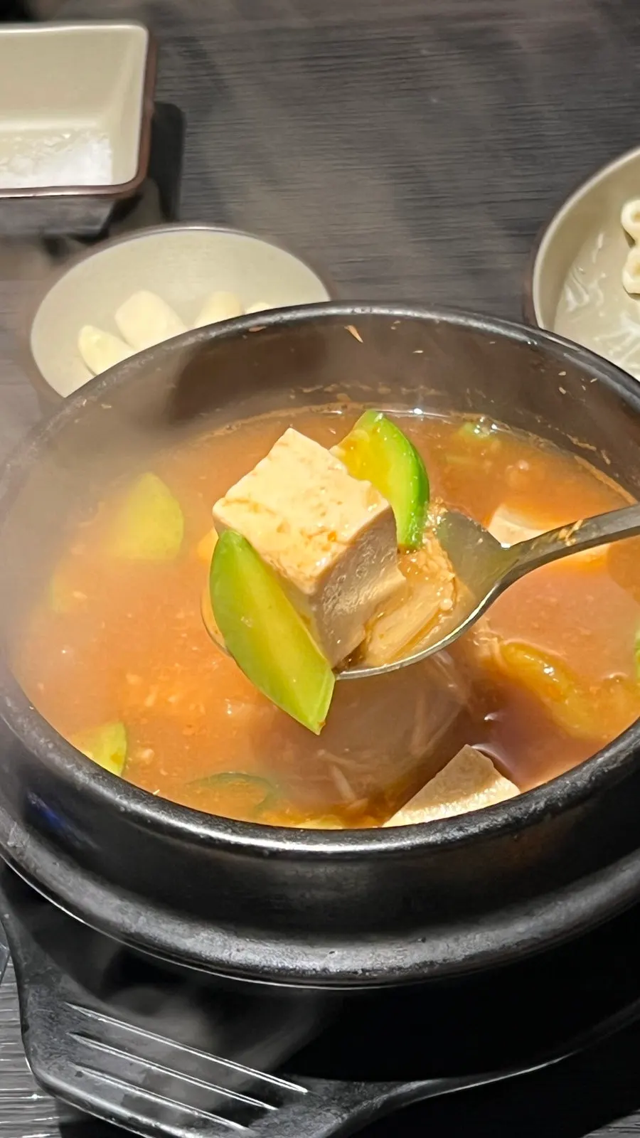Meat and fat cooking on the cauldron-lid plate