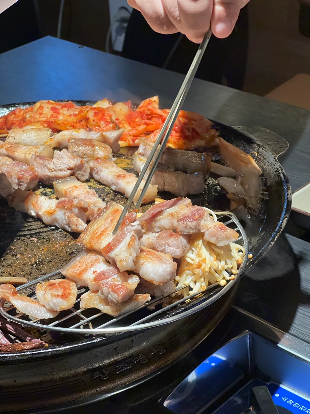 Close-up of grilled pork belly with side vegetables