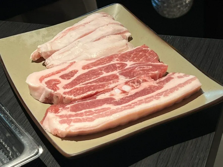 Cast-iron cauldron lid grill set in the middle of the table