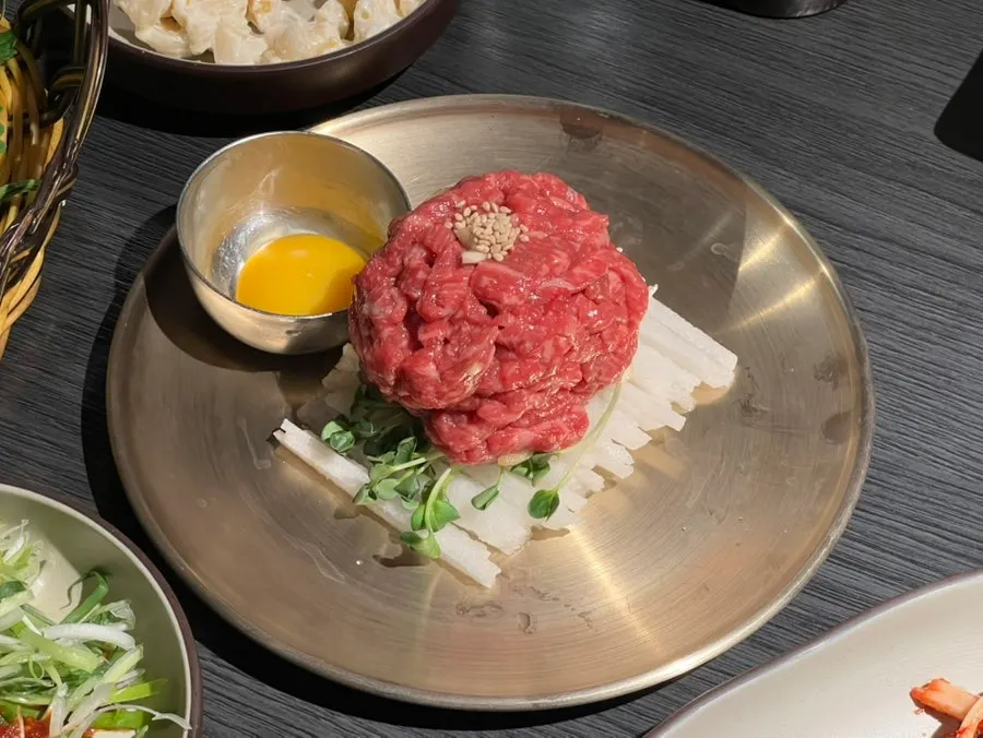 Yukhoe included in the set with an egg yolk on top