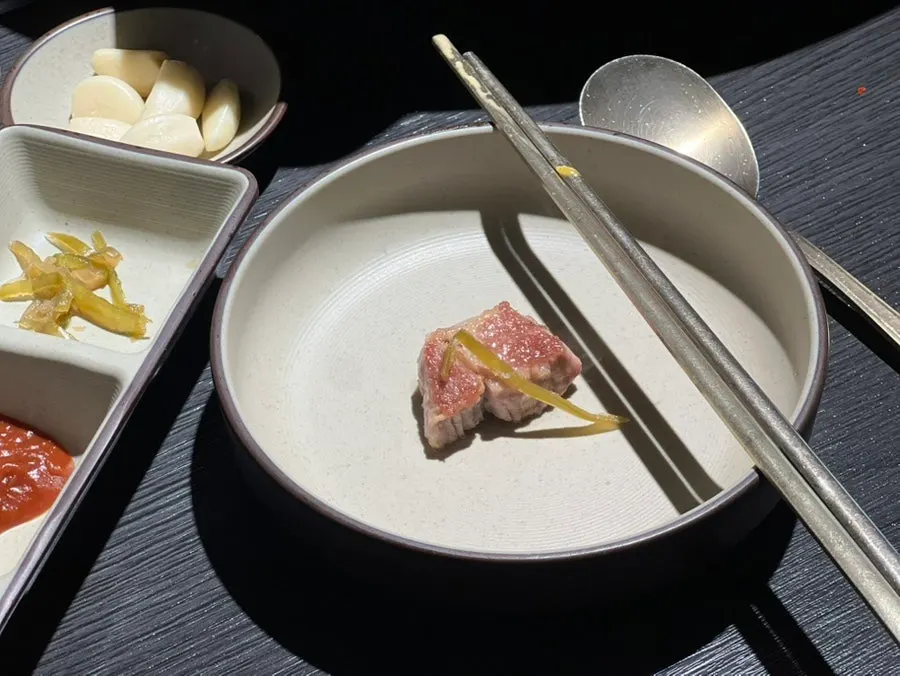 A finished piece of grilled pork belly and neck