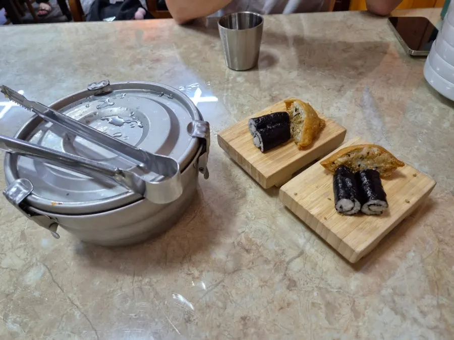 Table with Chungmu gimbap and seokbakji
