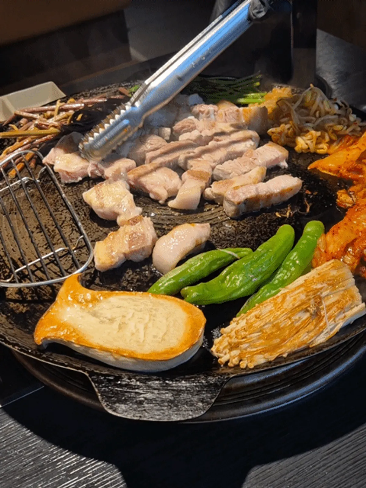 Staff member grilling domestic Duroc pork