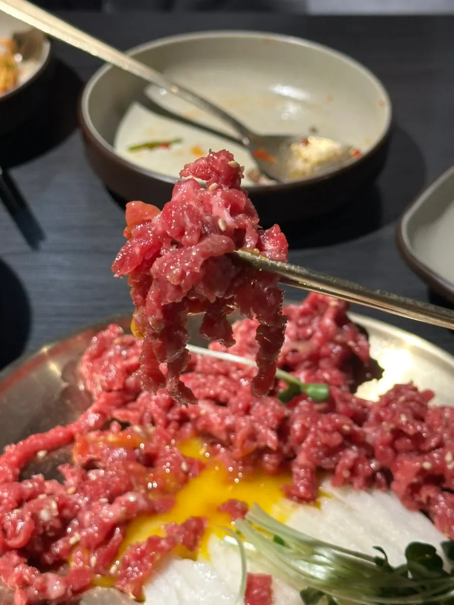 Beef tartare mixed after breaking the egg yolk