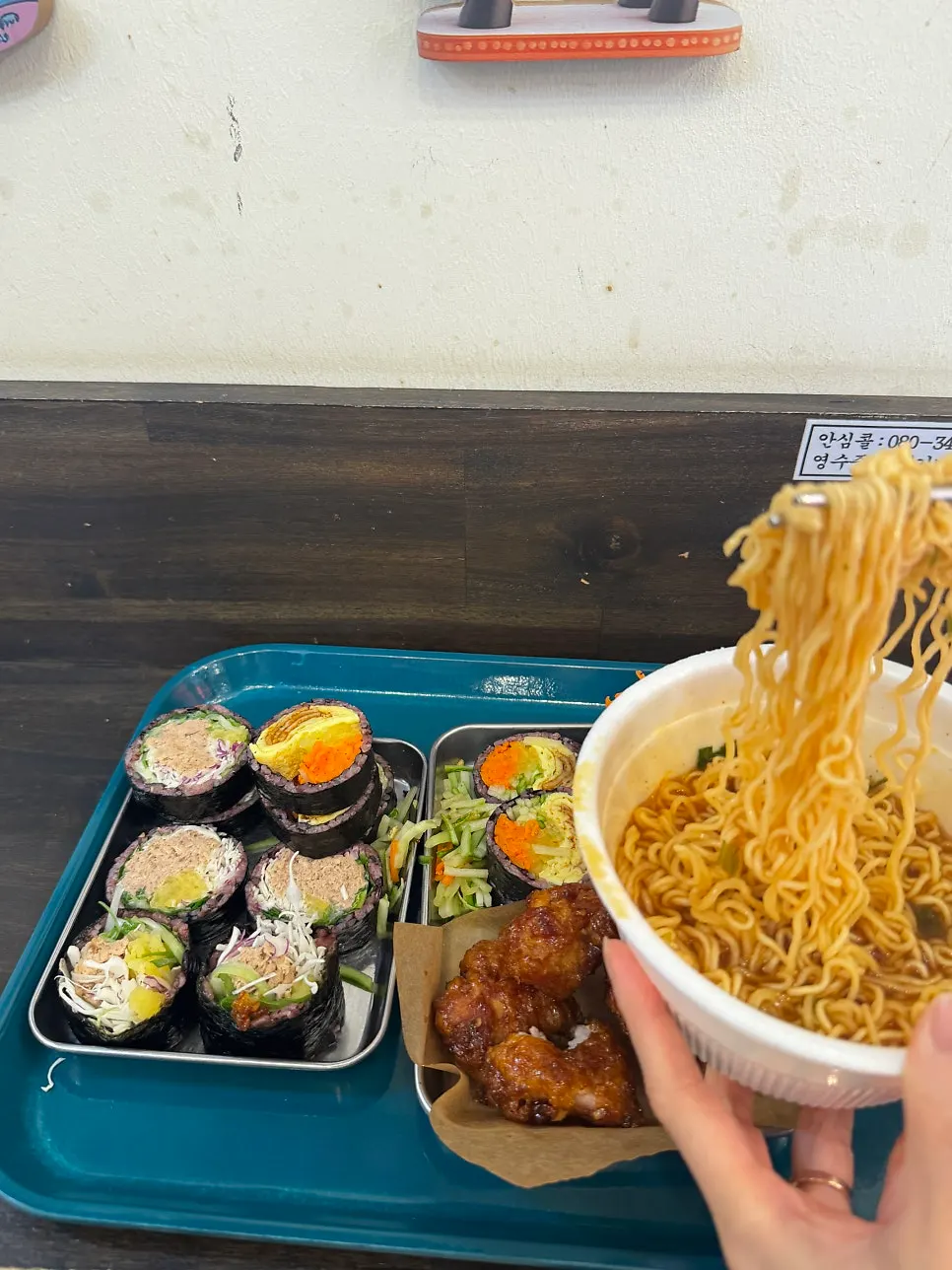 A piece of dakgangjeong picked up with chopsticks
