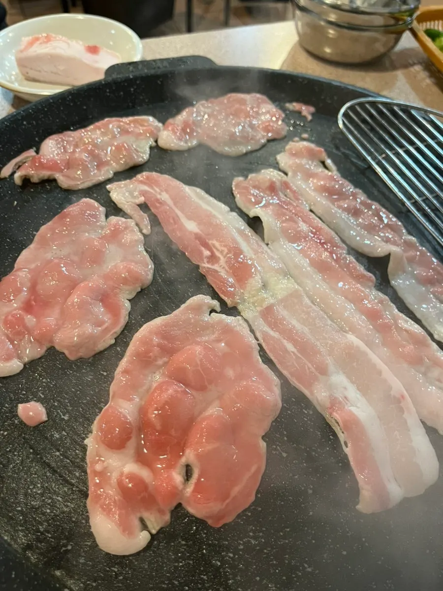 Thin shaved pork rolled up on a plate