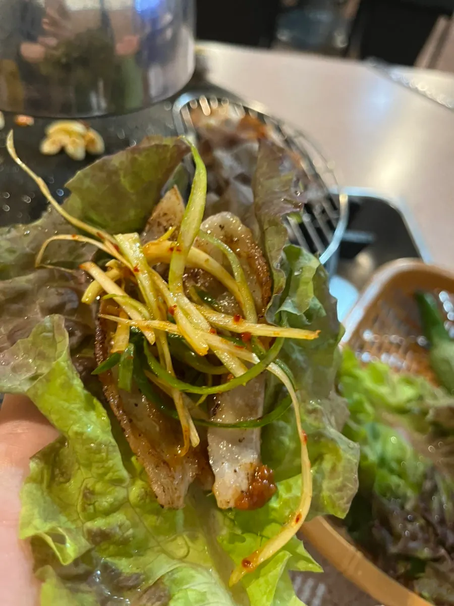 Shaved pork belly dipped in sauce