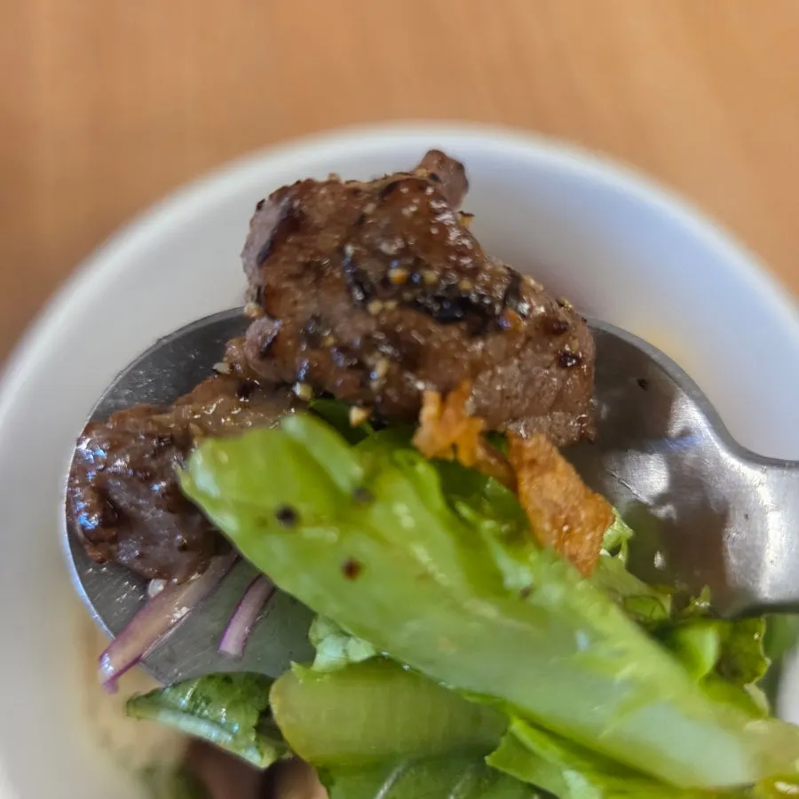 Poke bowl with steak and vegetables mixed together