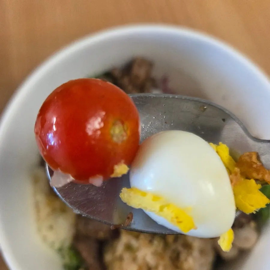 A hearty poke bowl with cherry tomatoes and quail eggs