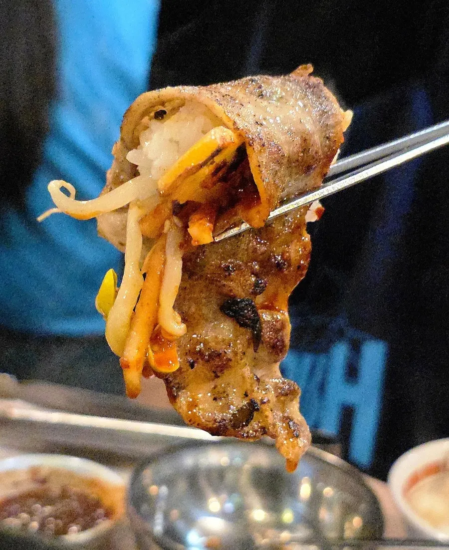 Thin-sliced pork belly dipped in sauce