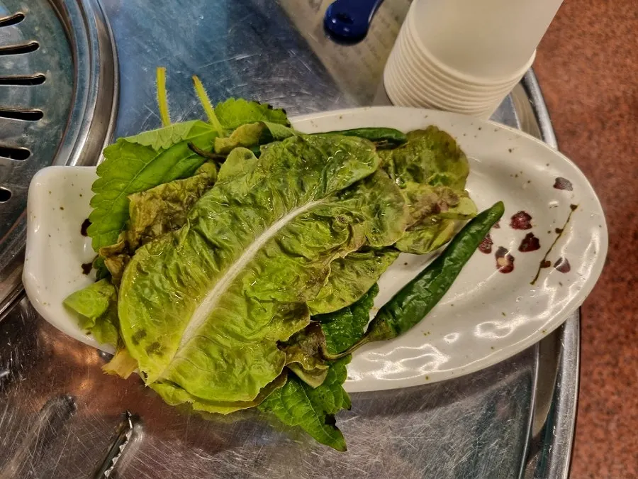 Lettuce wraps, scallion kimchi, and napa cabbage kimchi side dishes