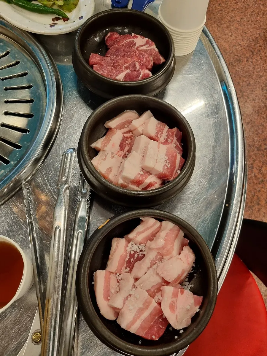 Pork belly and premium pork neck served in separate single-serving dishes