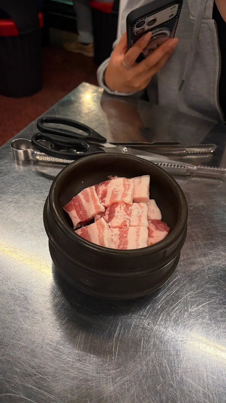 Raw plate of charcoal coarse-salt pork belly, two servings