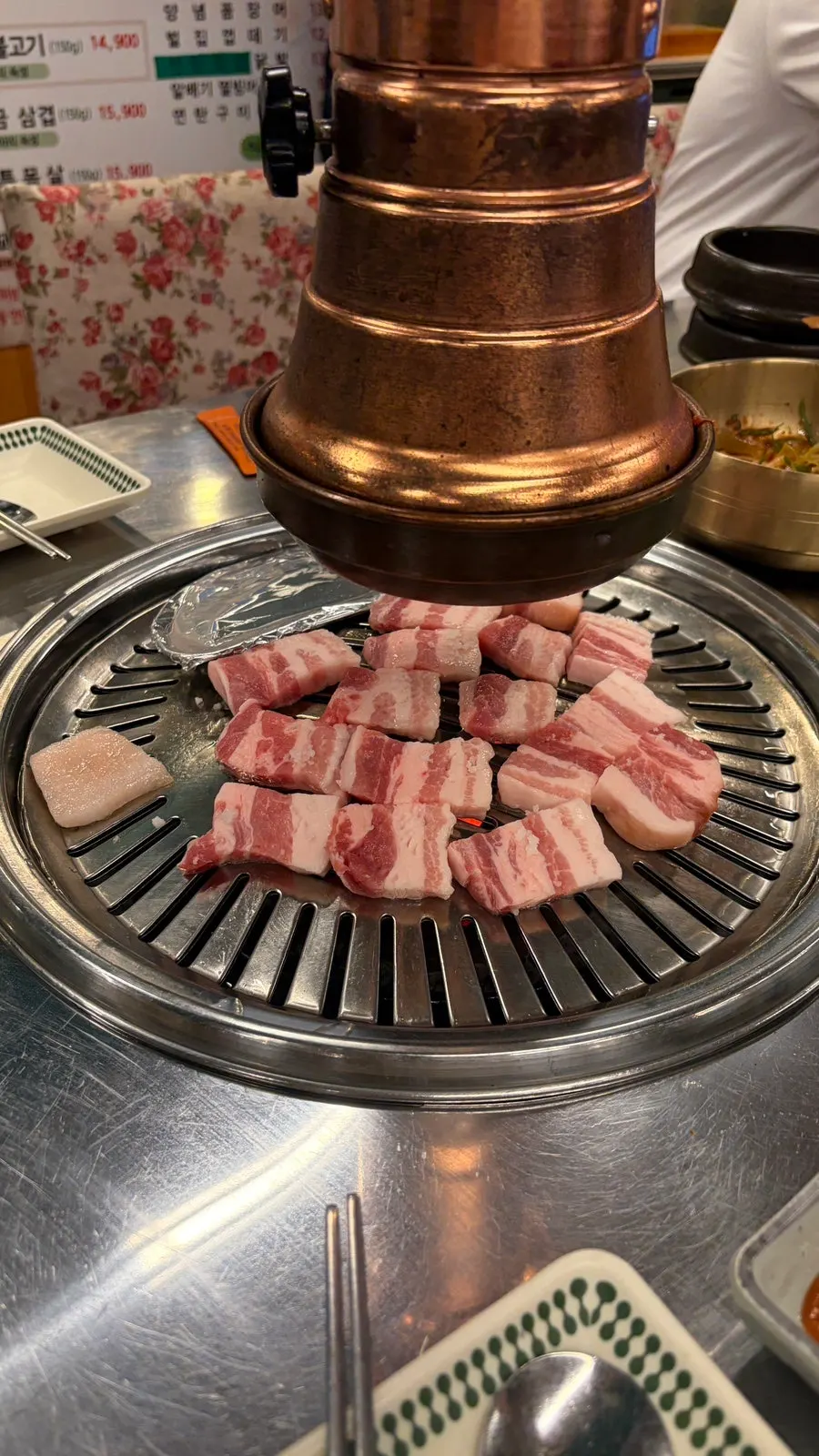 Pork belly grilling over the charcoal fire