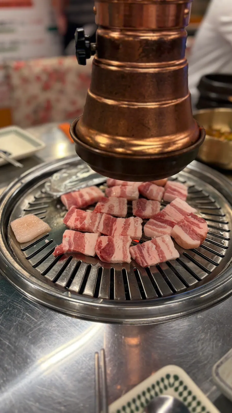 Charcoal-grilled pork belly turning golden brown