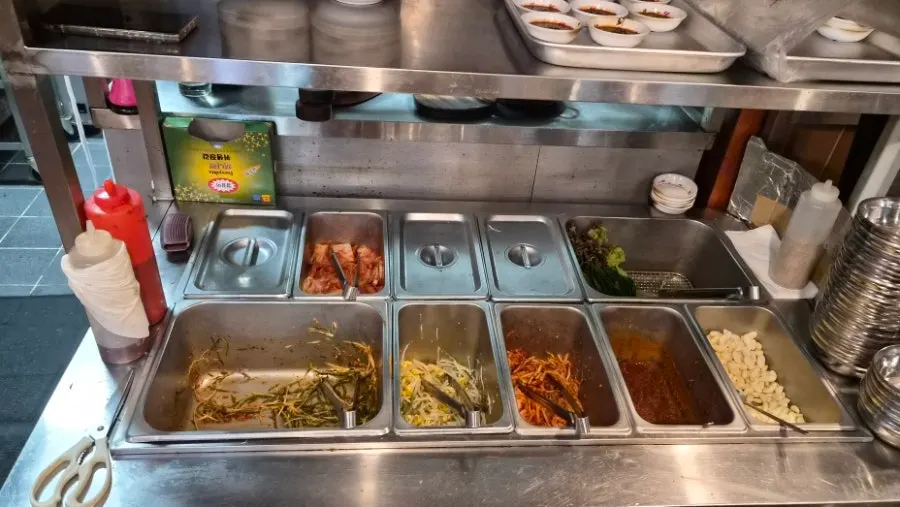 Self-serve bar with extra side dishes and wrap vegetables