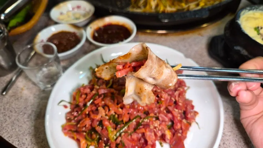 Table with yukhoe and grilled pork belly served together