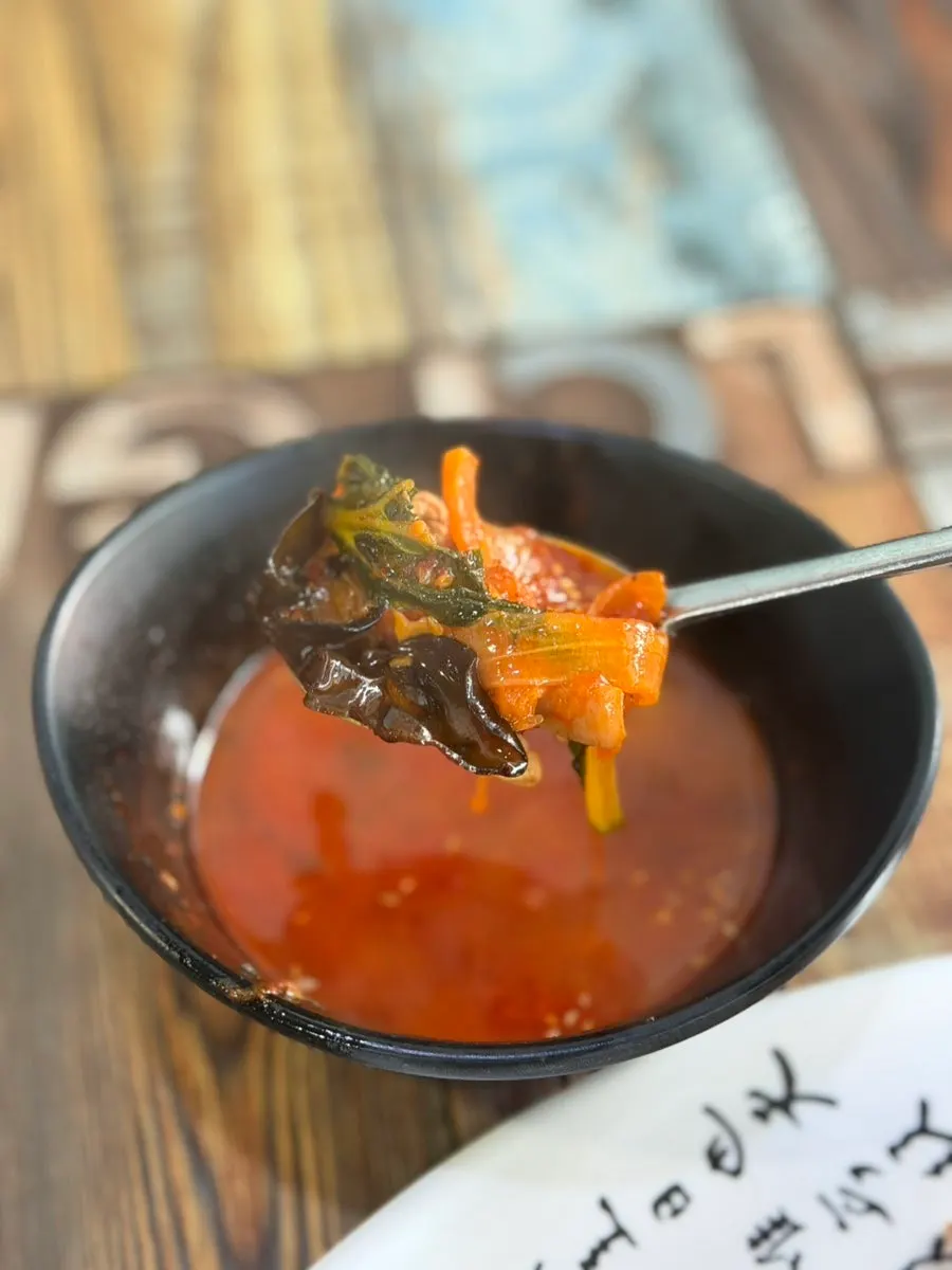 Jjamppong broth loaded with ingredients, served with the fried rice