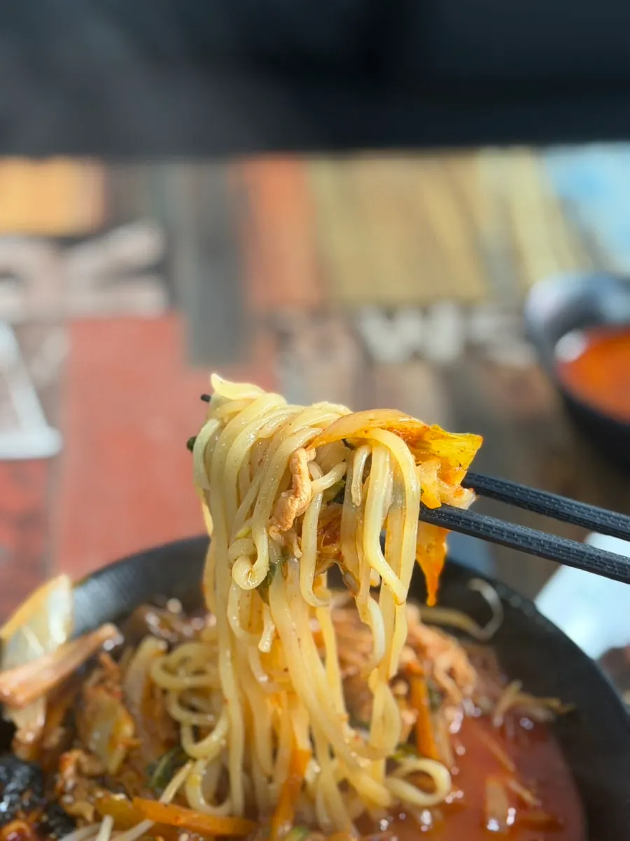 Jjamppong noodles lifted with chopsticks