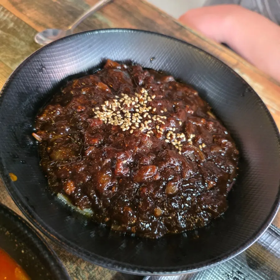 A glossy bowl of spicy ulzzajang