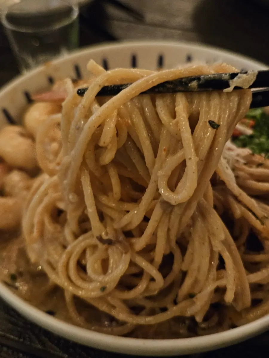 Close-up of pasta noodles soaked in crab tomalley sauce