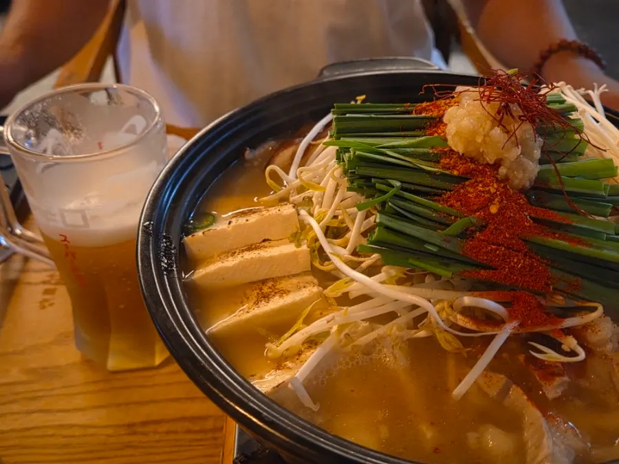 Motsunabe served with a glass of beer