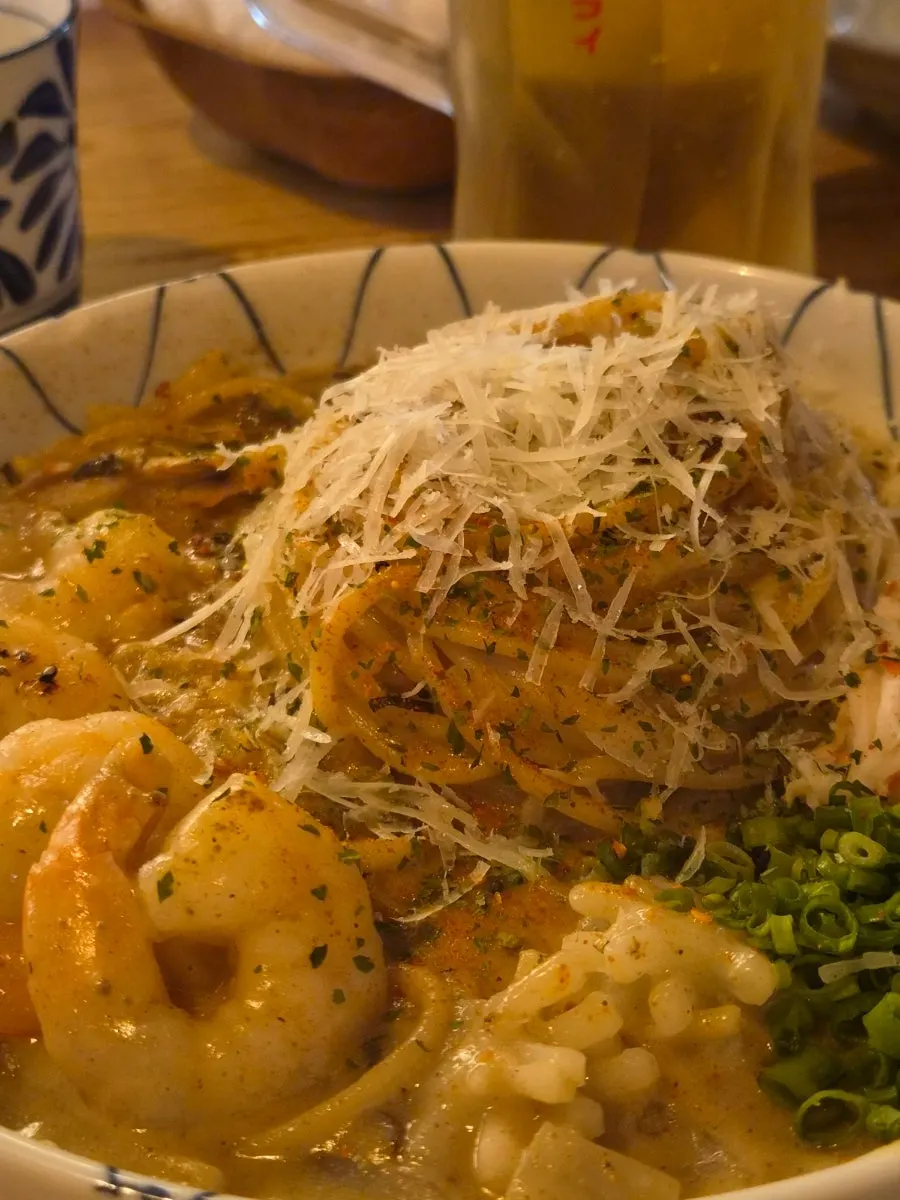 Crab tomalley pasta topped with shrimp