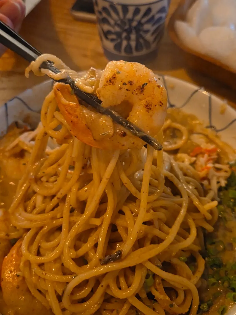 A bite showing the pasta's springy noodles