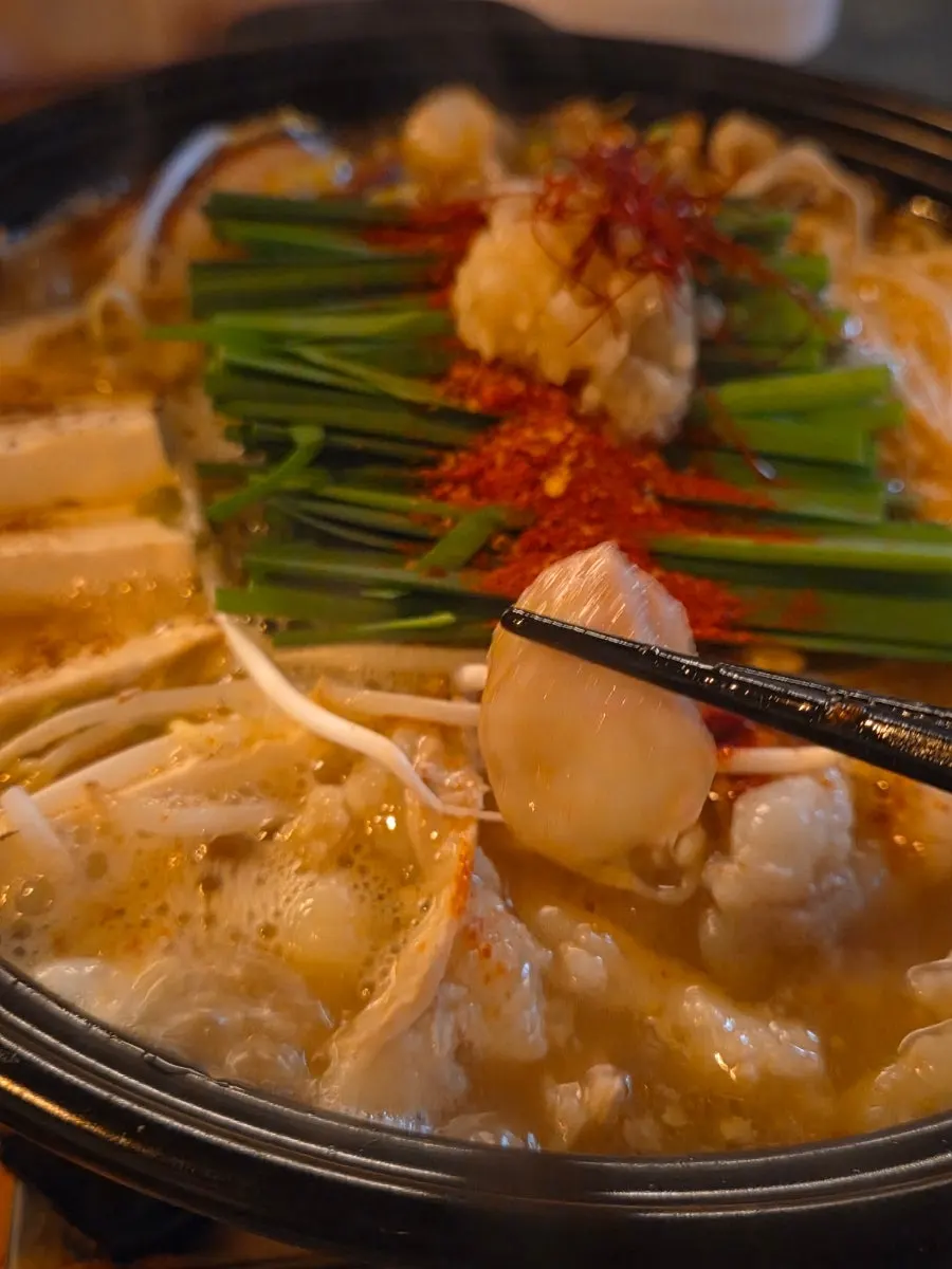 Table spread with motsunabe and crab tomalley pasta together