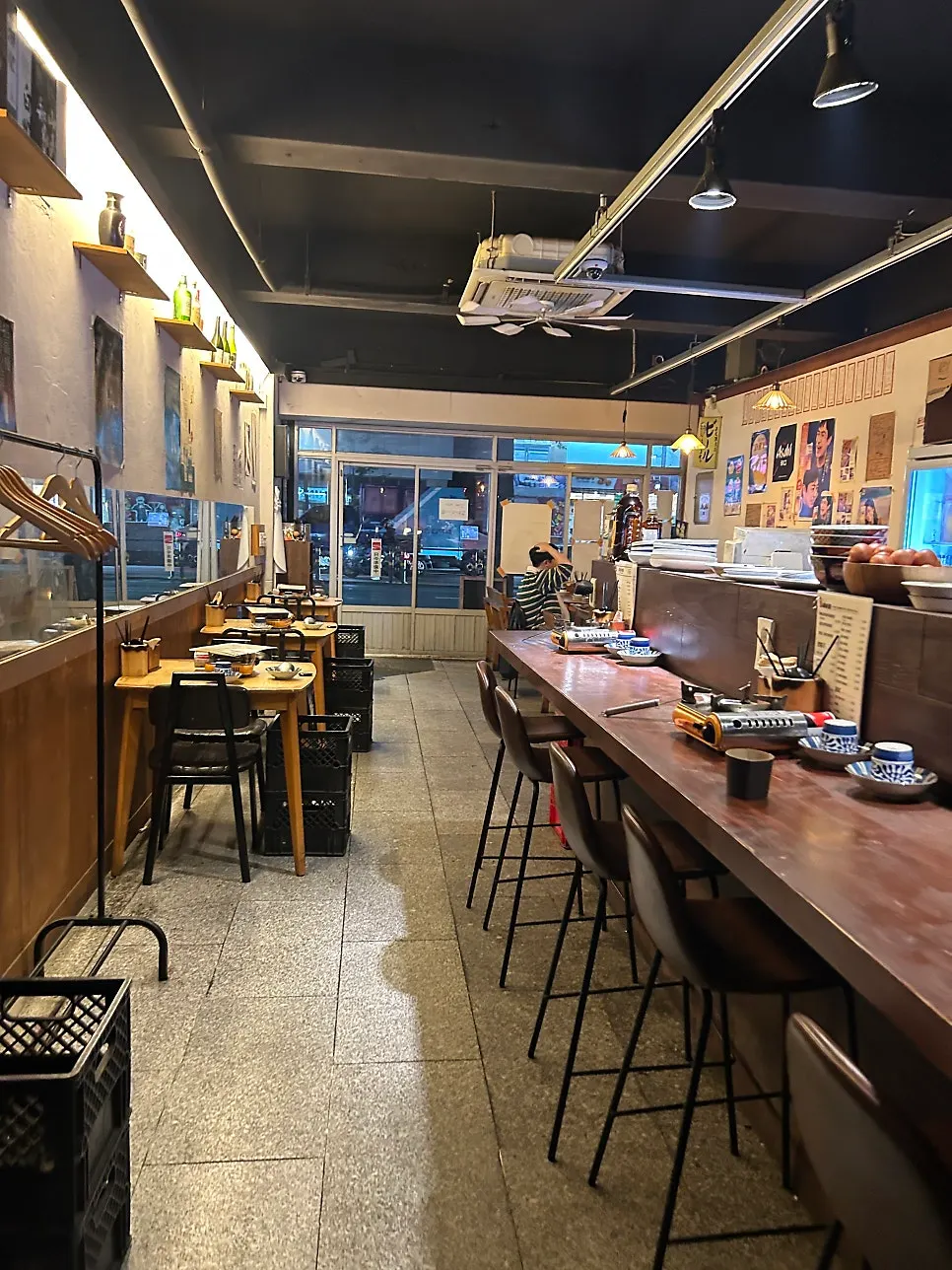 Long indoor space with table seating and bar seats at Gyodong Nakwon