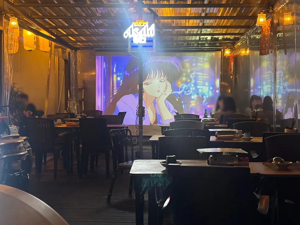 Table seating and large screen inside Gyodong Nakwon
