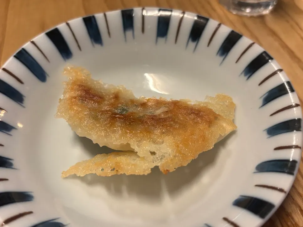 Yaki gyoza split in half showing juicy filling