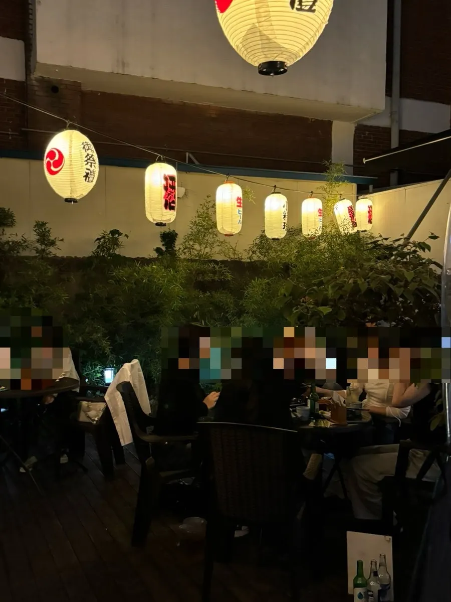 Inside Gyodong Nakwon with a Ghibli film playing
