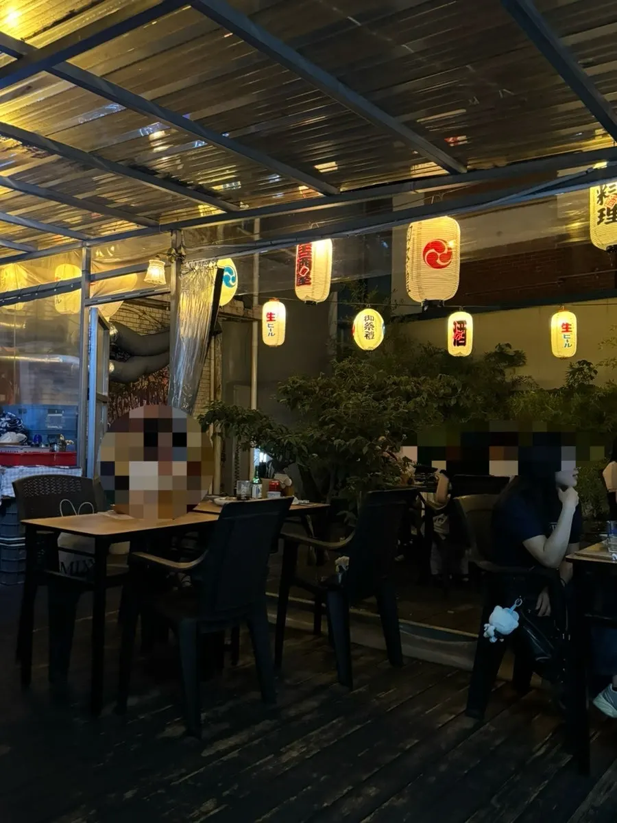 Gyodong Nakwon's outdoor tent at night with lanterns lit