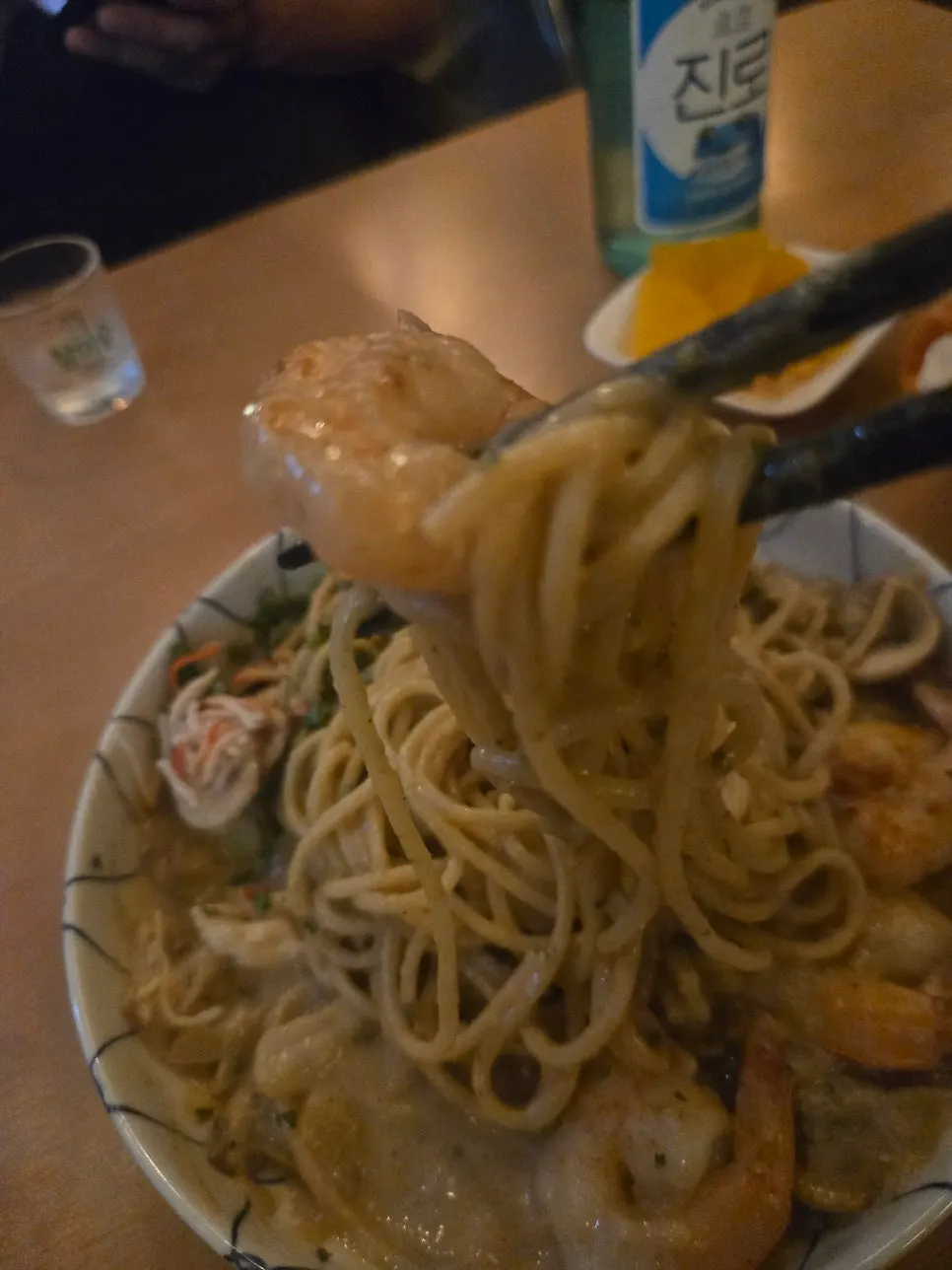 Close-up of crab tomalley pasta topped with cheese powder and parsley
