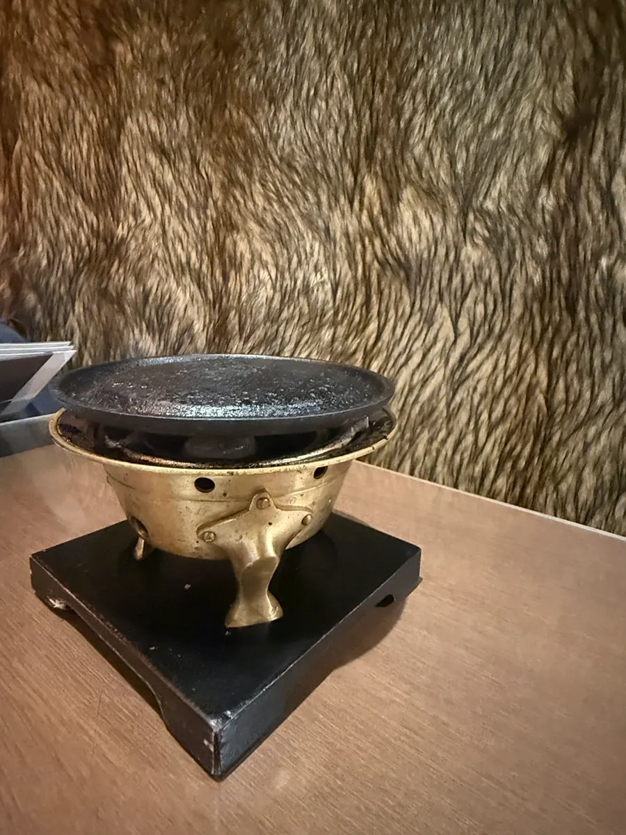 Individual bangjja yugi brazier set on a table