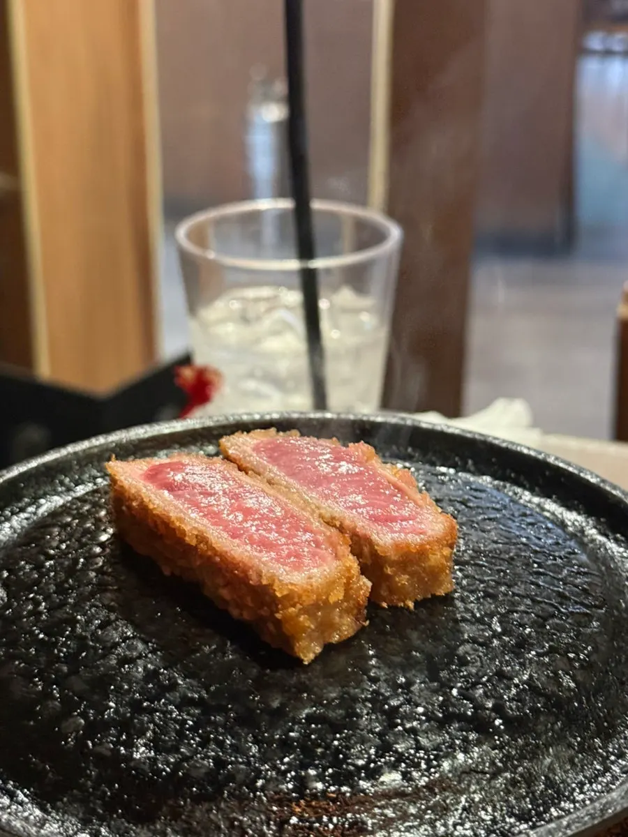 A piece of gyukatsu with salt and fresh wasabi