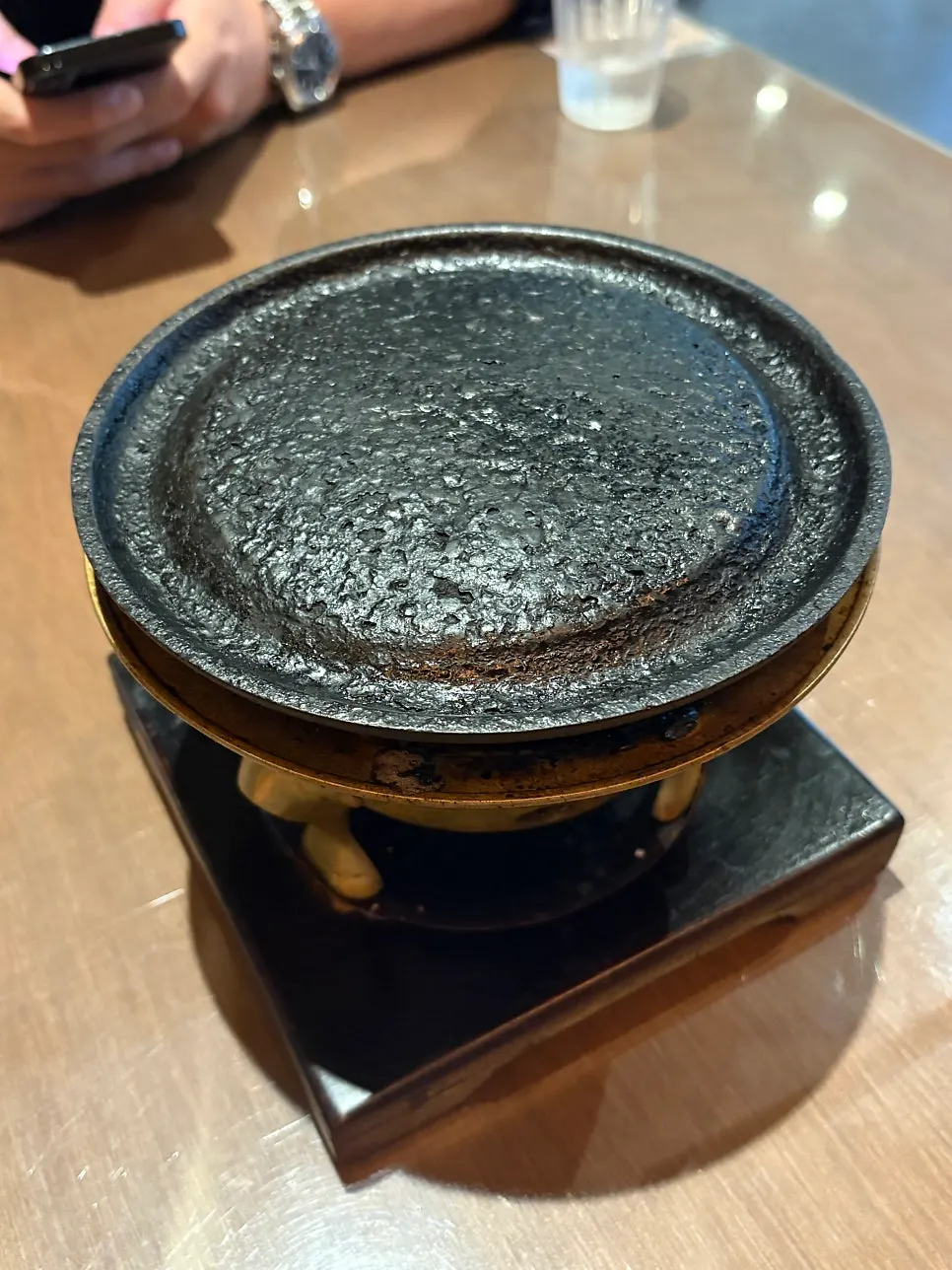 A piece of gyukatsu dipped in sauce and topped with wasabi