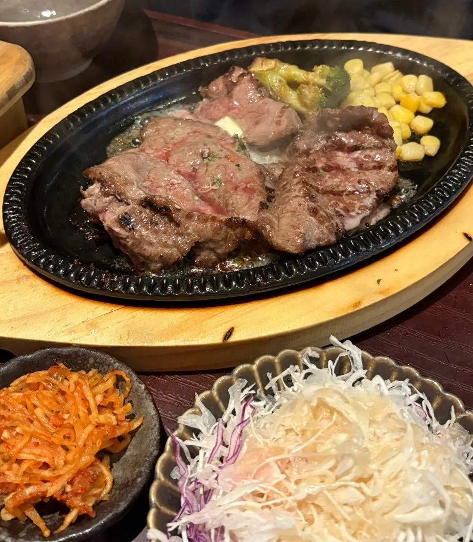 Sizzling steak with corn and broccoli on the iron plate