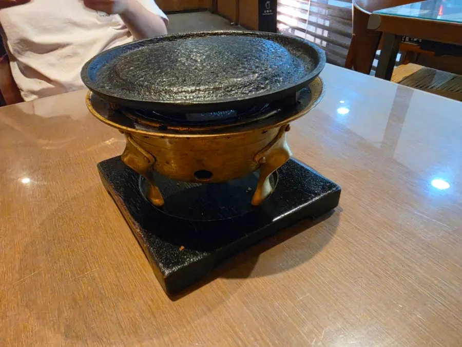 Table with a custom-made brass individual brazier