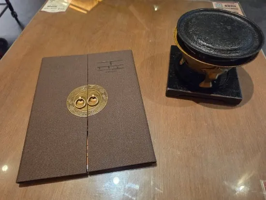 Personal brass brazier at the center of the table