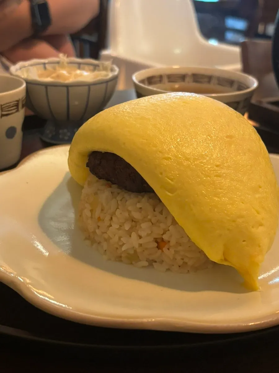 Whole hambagu patty visible beneath the egg
