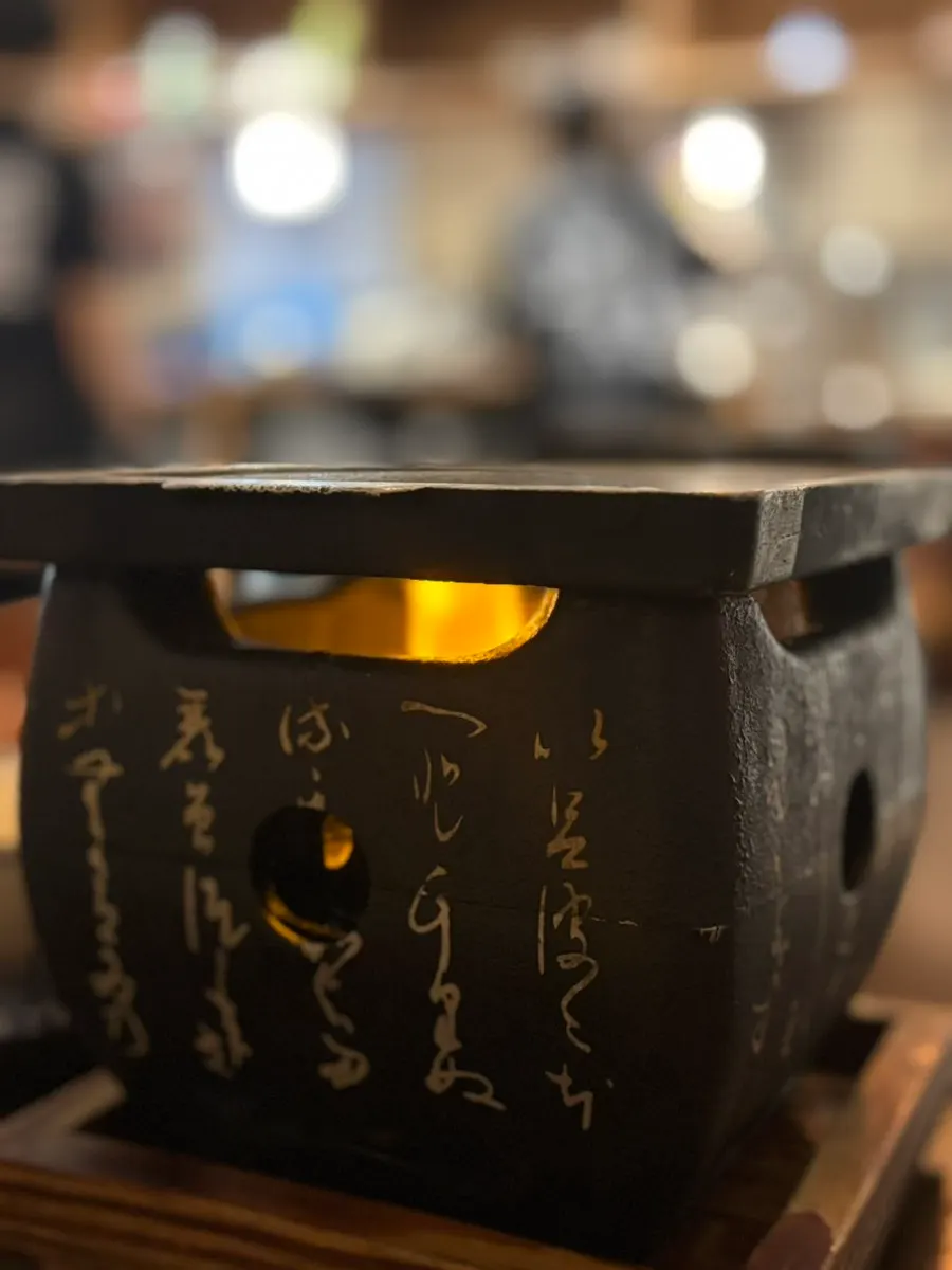 Lit brazier at the table